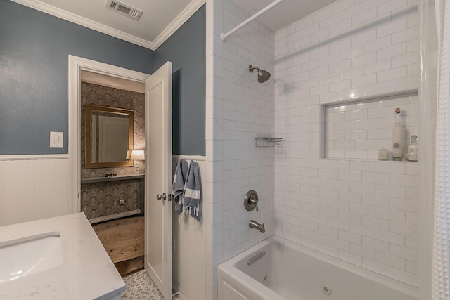 bathroom featuring visible vents, wainscoting, ornamental molding, a combined bath / shower with jetted tub, and vanity