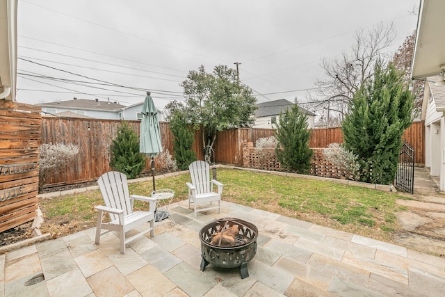 view of patio / terrace with an outdoor fire pit and a fenced backyard