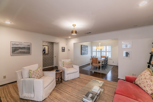 living area with recessed lighting, wood finished floors, visible vents, a ceiling fan, and baseboards