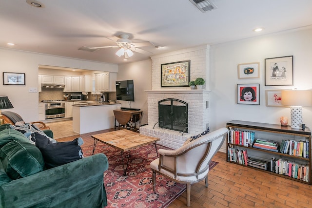 living room with brick floor, recessed lighting, a fireplace, visible vents, and a ceiling fan