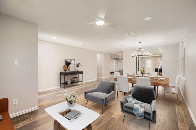 living room featuring recessed lighting, wood finished floors, and baseboards