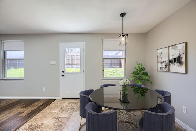 dining area with wood finished floors and baseboards