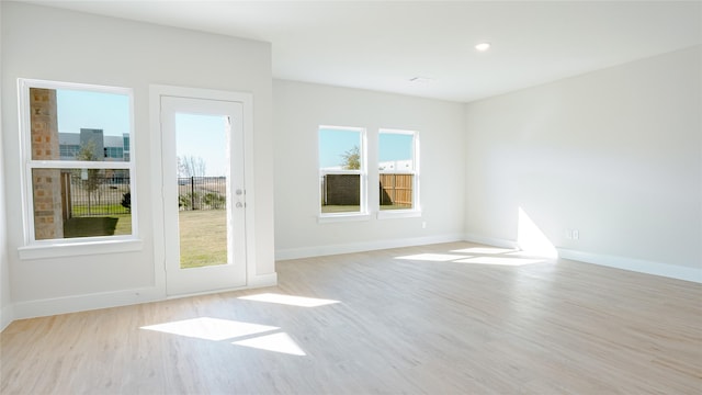 unfurnished room with wood finished floors and baseboards