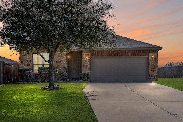 view of front of home featuring stone siding, fence, and a lawn