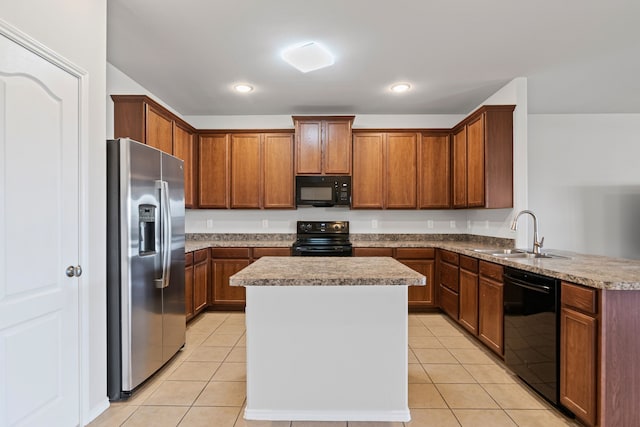 kitchen with black appliances, light tile patterned flooring, a sink, and a center island