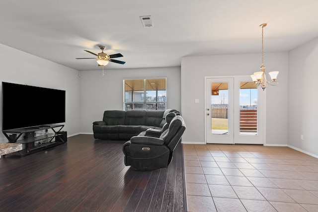 living area with a wealth of natural light, visible vents, and baseboards