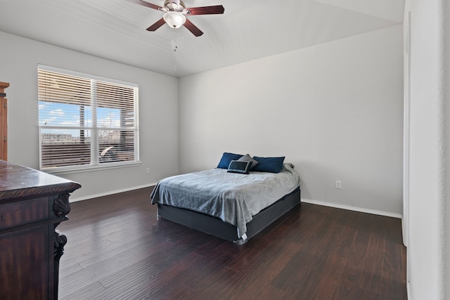 bedroom with a ceiling fan, dark wood-style flooring, and baseboards