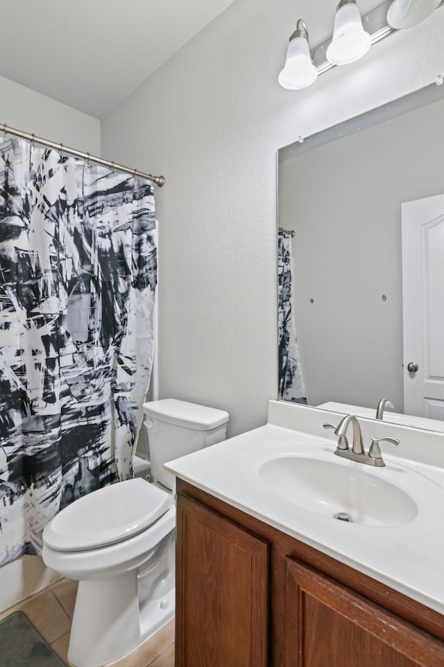 full bath featuring vanity, tile patterned flooring, and toilet