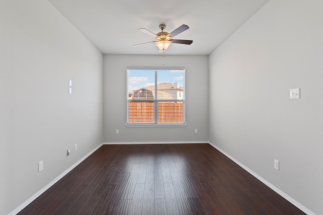 unfurnished room with wood finished floors, a ceiling fan, and baseboards