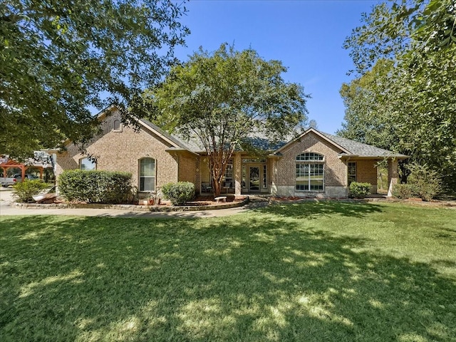 single story home with brick siding and a front yard