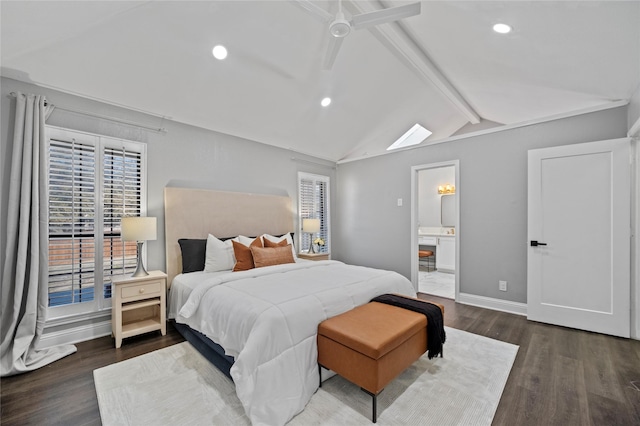 bedroom with lofted ceiling with beams, ensuite bathroom, wood finished floors, a ceiling fan, and baseboards