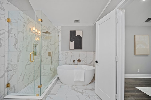 full bath with marble finish floor, visible vents, a freestanding tub, and a marble finish shower