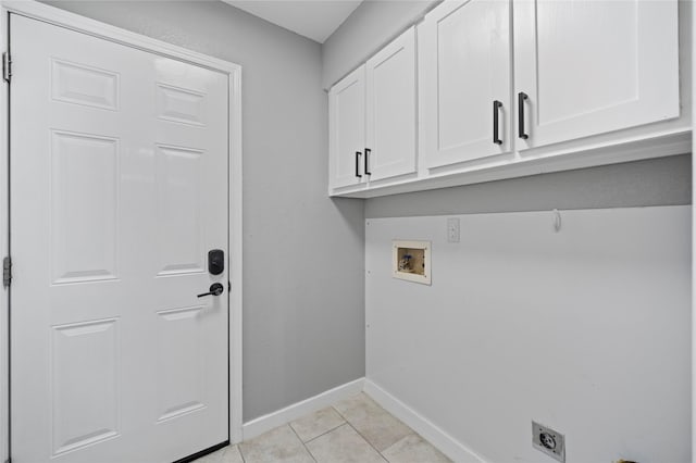 washroom featuring light tile patterned floors, hookup for an electric dryer, washer hookup, baseboards, and cabinet space