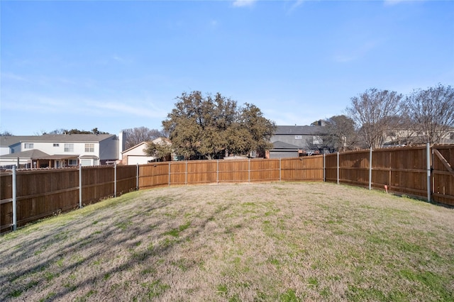 view of yard featuring a residential view and a fenced backyard