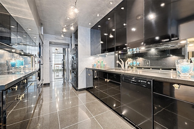 kitchen featuring black appliances, granite finish floor, dark cabinets, and a sink