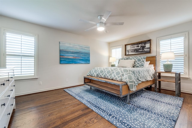 bedroom with a ceiling fan, baseboards, and wood finished floors