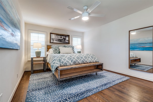 bedroom featuring ceiling fan, baseboards, and wood finished floors