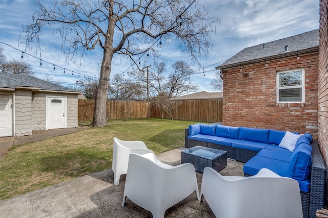 view of patio with outdoor lounge area, a fenced backyard, and an outdoor structure