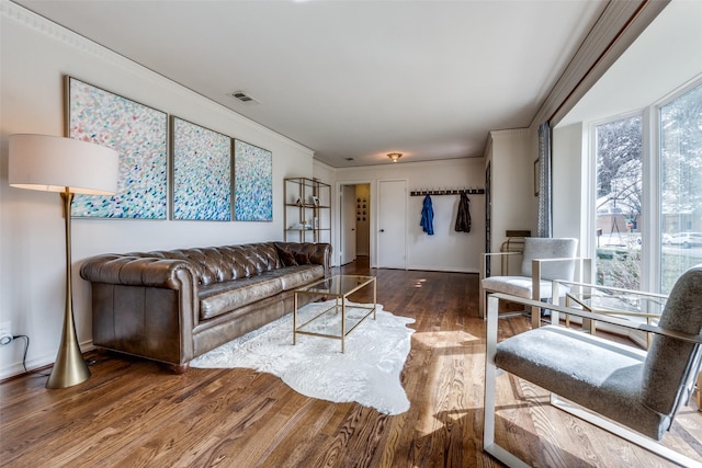 living room featuring visible vents and wood finished floors