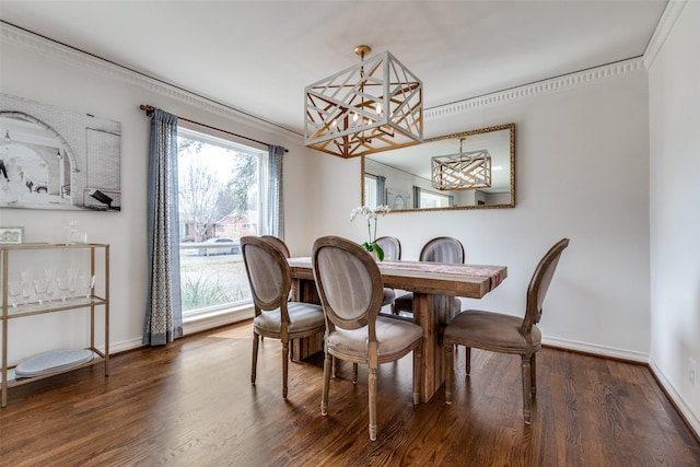 dining room with ornamental molding, an inviting chandelier, wood finished floors, and baseboards