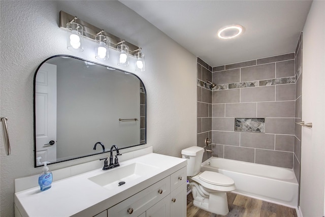 full bathroom featuring toilet, shower / bathtub combination, wood finished floors, and vanity