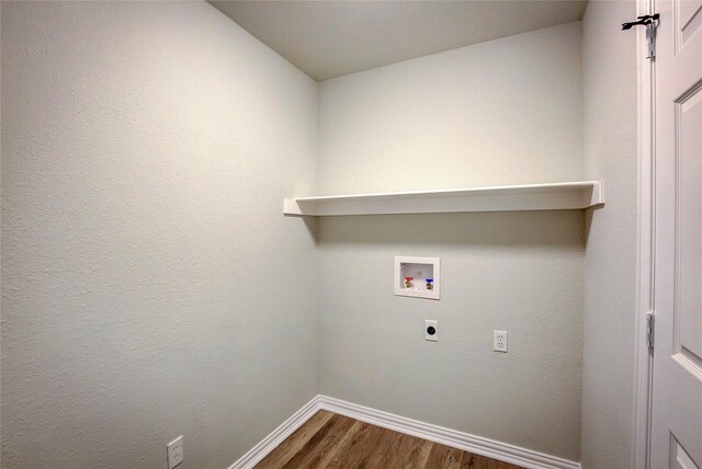 clothes washing area featuring laundry area, baseboards, dark wood finished floors, hookup for a washing machine, and electric dryer hookup