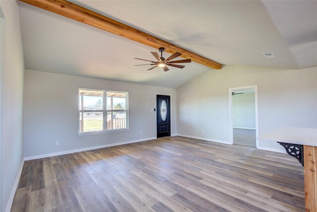 unfurnished living room with vaulted ceiling with beams, ceiling fan, wood finished floors, visible vents, and baseboards