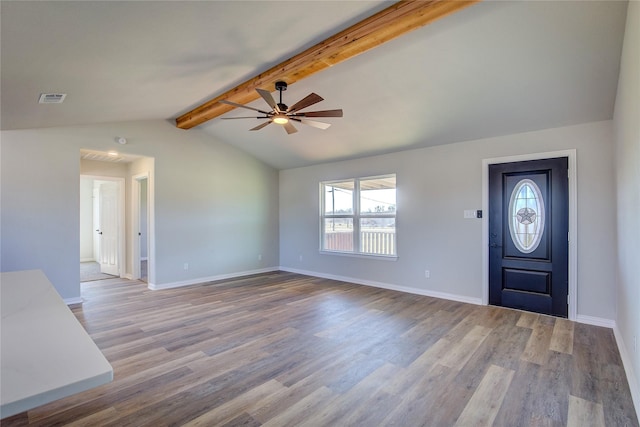 foyer entrance with lofted ceiling with beams, baseboards, visible vents, and wood finished floors