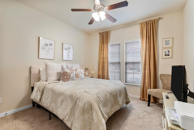 bedroom featuring ceiling fan, baseboards, and light colored carpet