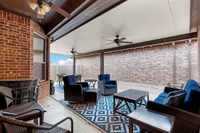 view of patio / terrace featuring ceiling fan, fence, and an outdoor hangout area