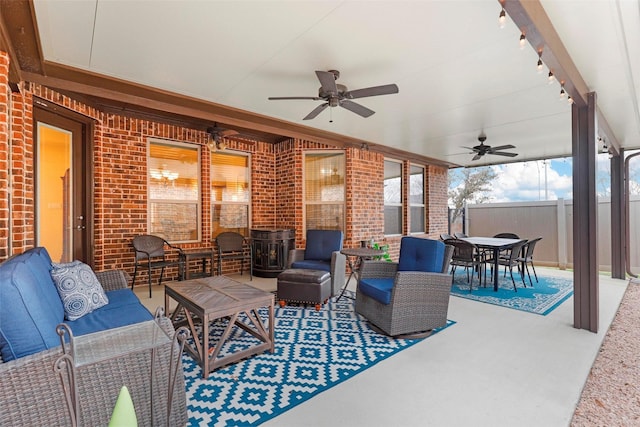 view of patio with a ceiling fan, outdoor dining area, fence, and an outdoor hangout area