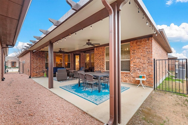 view of patio with ceiling fan, outdoor lounge area, fence, and a gate