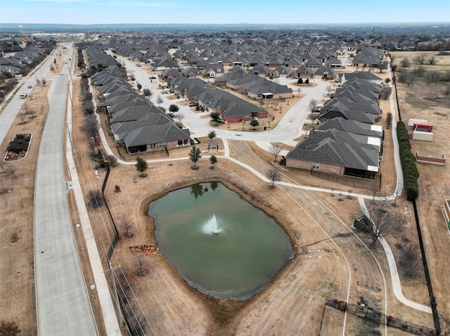 drone / aerial view featuring a water view and a residential view