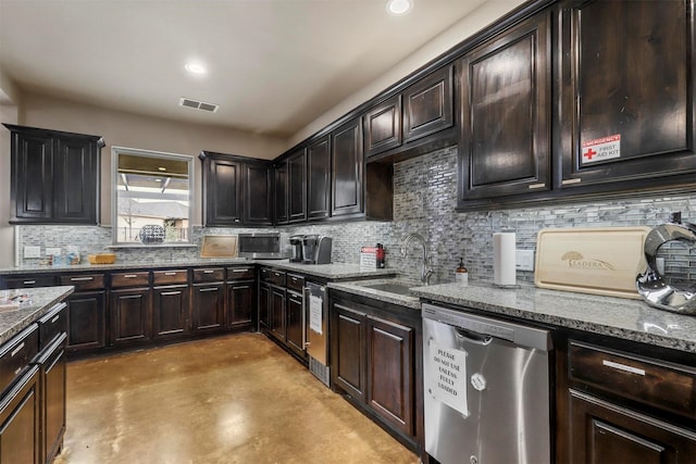 kitchen featuring a sink, visible vents, stainless steel dishwasher, backsplash, and dark stone counters