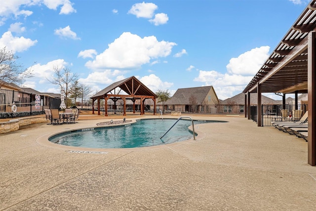 community pool featuring a patio area, fence, and a gazebo