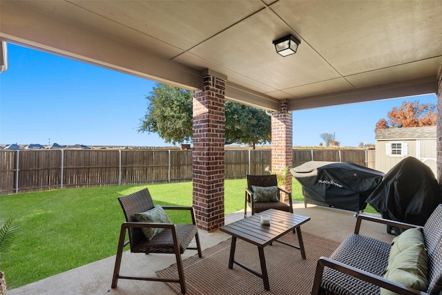 view of patio with an outdoor hangout area, area for grilling, and a fenced backyard