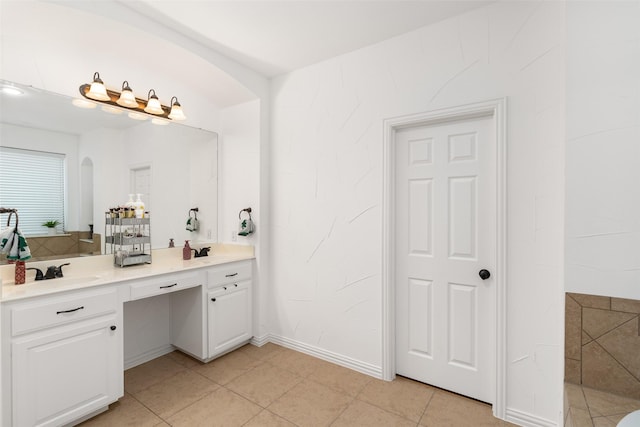 full bathroom featuring double vanity, tile patterned floors, and baseboards