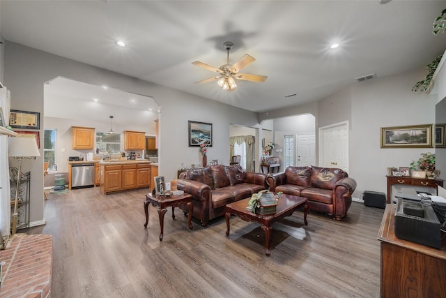 living area with light wood-type flooring, ceiling fan, visible vents, and recessed lighting