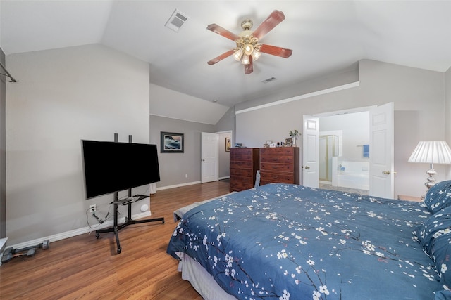 bedroom featuring vaulted ceiling, wood finished floors, visible vents, and baseboards