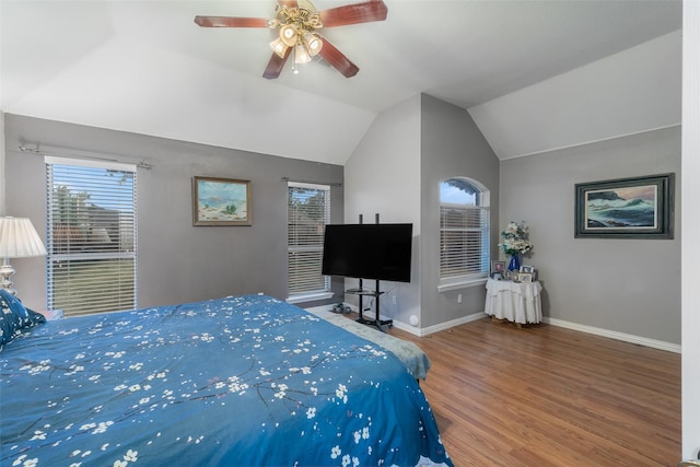 bedroom featuring lofted ceiling, wood finished floors, a ceiling fan, and baseboards