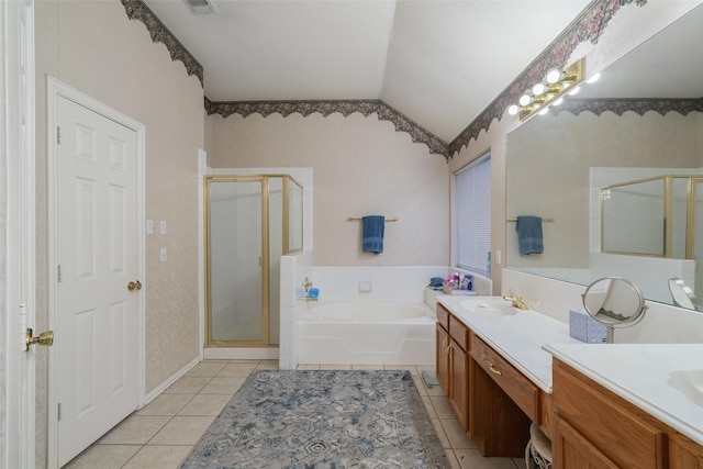 full bathroom featuring a stall shower, tile patterned flooring, lofted ceiling, and vanity