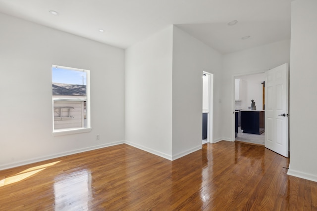 empty room featuring baseboards and wood finished floors
