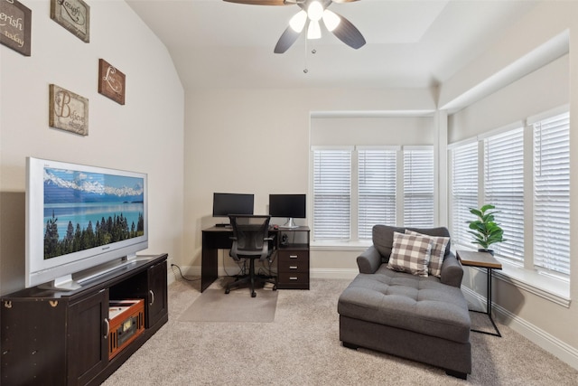 carpeted home office with baseboards, vaulted ceiling, and a ceiling fan