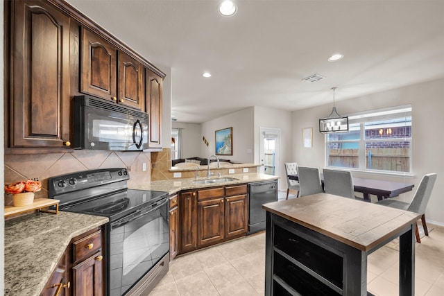 kitchen with black appliances, backsplash, a sink, and a healthy amount of sunlight