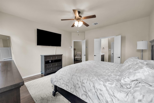 bedroom featuring dark wood-type flooring, visible vents, ceiling fan, and baseboards