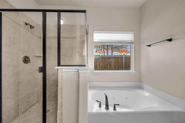 bathroom with a jetted tub and a shower stall