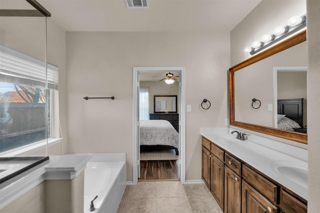 ensuite bathroom featuring a garden tub, a sink, ensuite bath, and double vanity