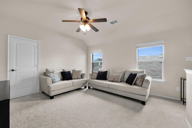 carpeted living area featuring lofted ceiling, plenty of natural light, visible vents, and a ceiling fan