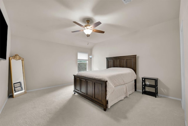 bedroom featuring a ceiling fan, lofted ceiling, light colored carpet, and baseboards