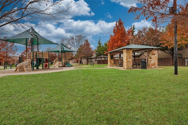 view of yard featuring playground community, fence, and a gazebo